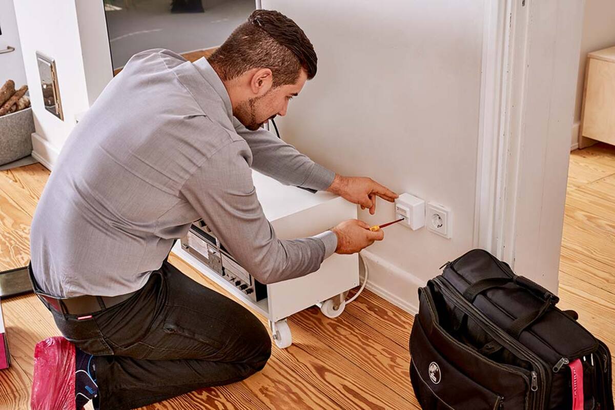 Technician installing a fibre connection in a home